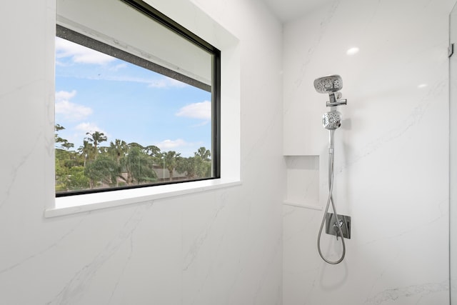 bathroom with tiled shower