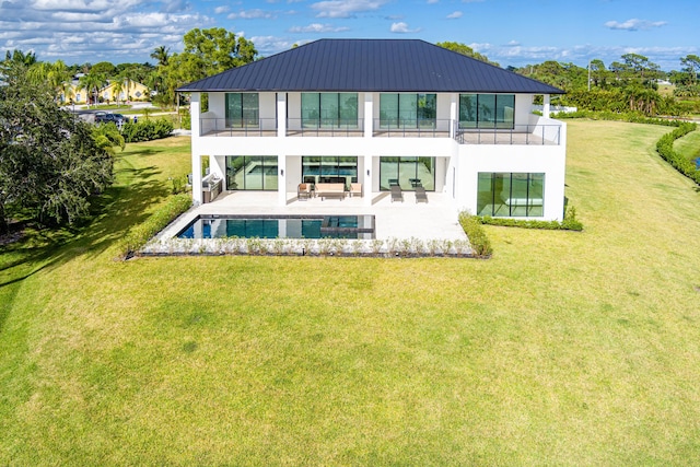 back of house with a lawn, a patio area, an outdoor living space, and a balcony