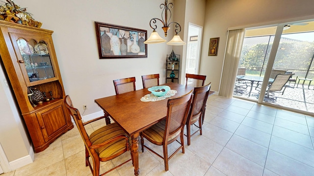 tiled dining space with a chandelier