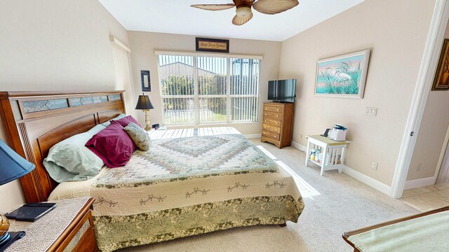 bedroom with ceiling fan and light carpet