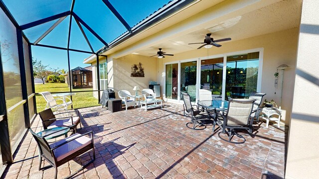 sunroom / solarium featuring ceiling fan