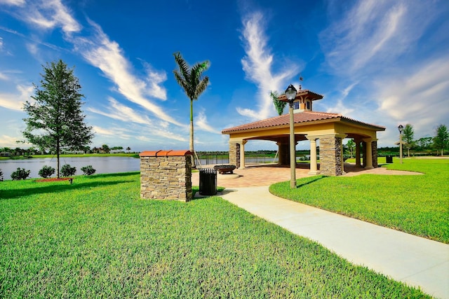 surrounding community featuring a gazebo, a yard, and a water view