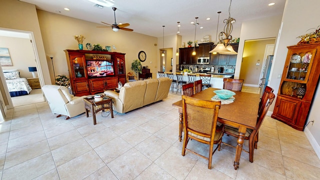 dining area featuring ceiling fan and light tile patterned floors