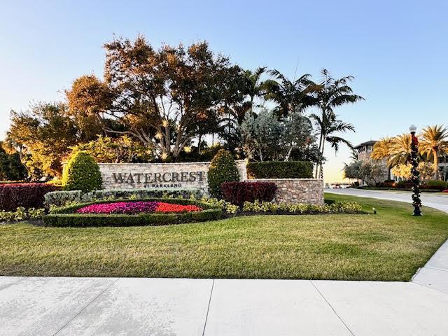 community sign featuring a lawn