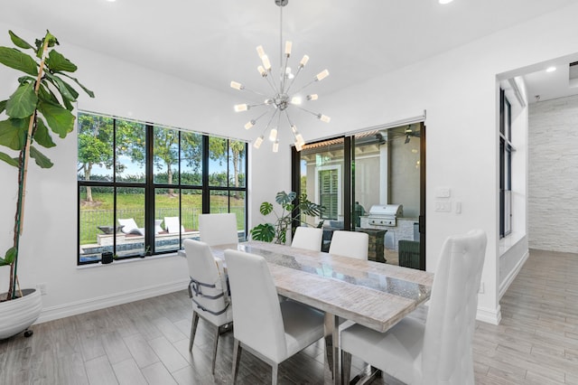 dining area featuring light hardwood / wood-style flooring and an inviting chandelier