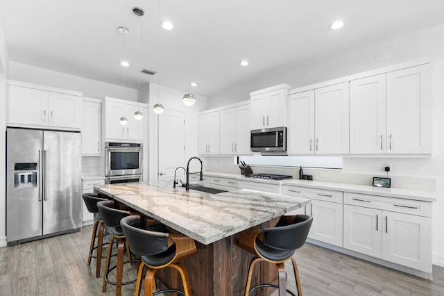 kitchen featuring sink, white cabinets, and stainless steel appliances