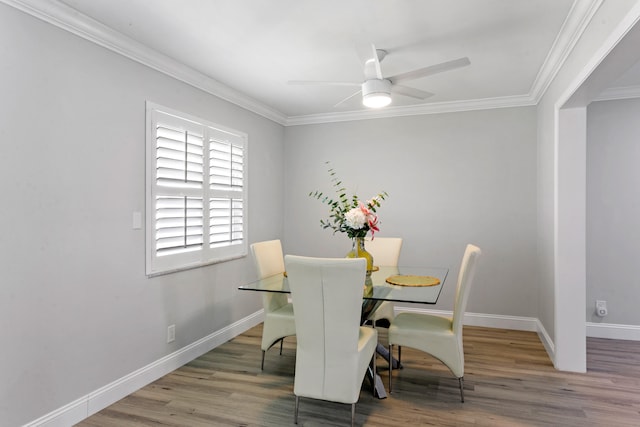 dining room with ceiling fan, crown molding, and light hardwood / wood-style flooring