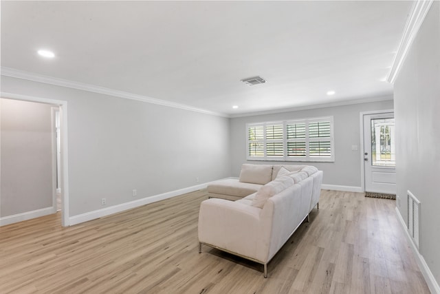 living room featuring crown molding and light hardwood / wood-style floors