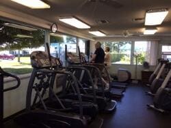 gym featuring ceiling fan and plenty of natural light