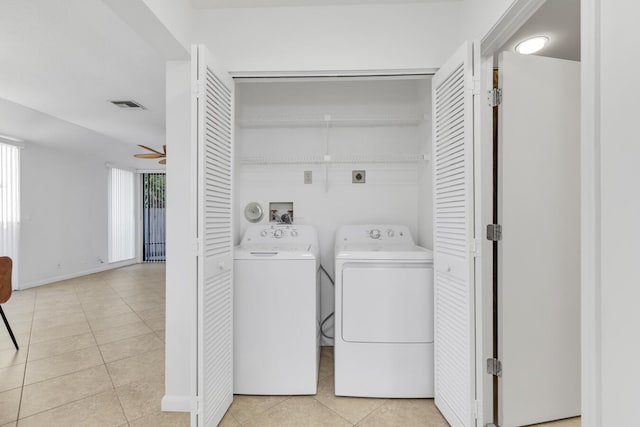 laundry room with separate washer and dryer, ceiling fan, and light tile patterned flooring