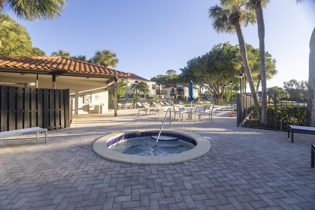 view of home's community featuring a patio and a hot tub