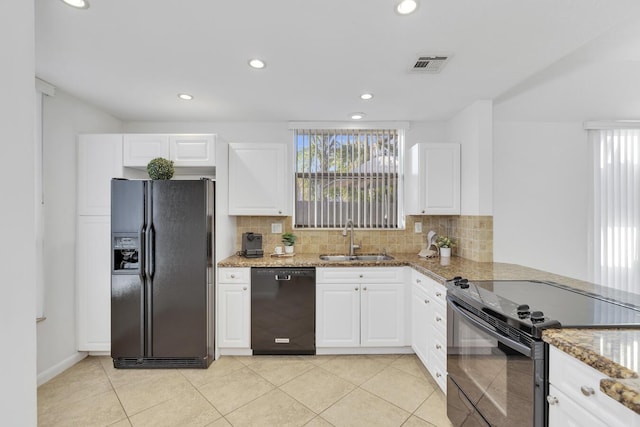 kitchen with backsplash, white cabinetry, sink, and black appliances