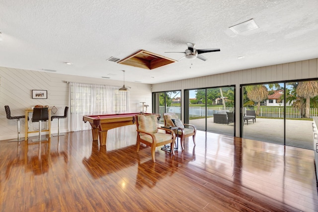 rec room featuring a textured ceiling, hardwood / wood-style flooring, ceiling fan, and pool table