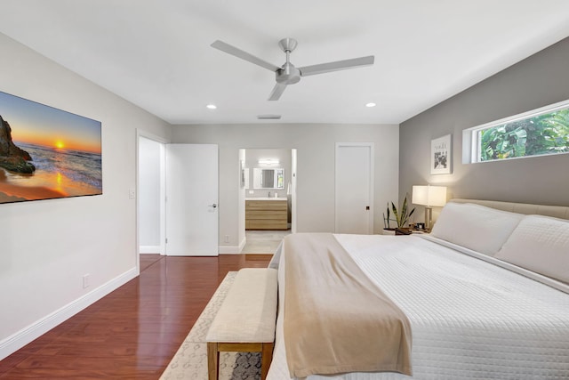 bedroom with ensuite bath, ceiling fan, and dark wood-type flooring