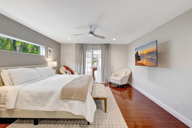 bedroom with multiple windows, ceiling fan, and hardwood / wood-style floors