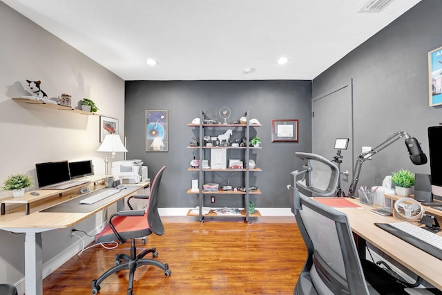 office space with wood-type flooring