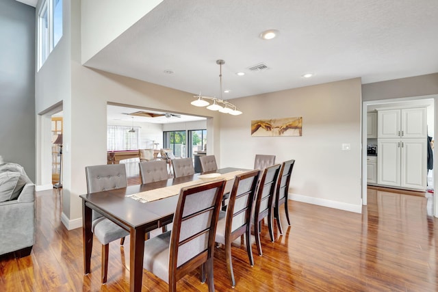 dining room featuring ceiling fan, a textured ceiling, and light wood-type flooring