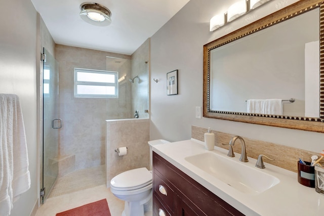 bathroom with tile patterned floors, vanity, toilet, and an enclosed shower