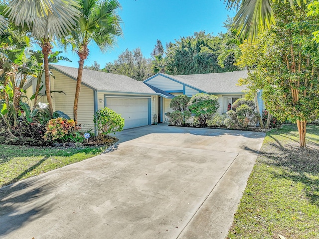 single story home featuring a garage and a front lawn