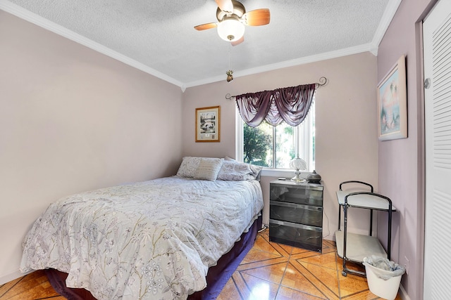 bedroom with ornamental molding, ceiling fan, a textured ceiling, and a closet