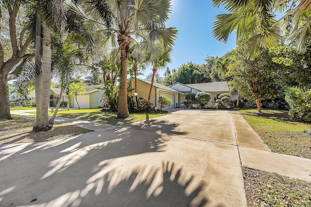 view of front of property with a garage and a front lawn