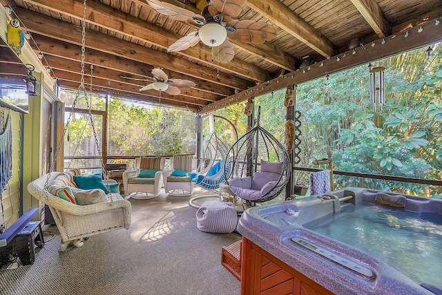 unfurnished sunroom with beamed ceiling and ceiling fan