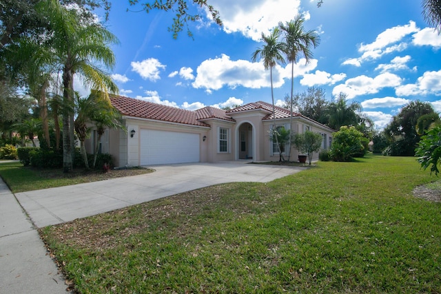 mediterranean / spanish-style house with a garage and a front lawn