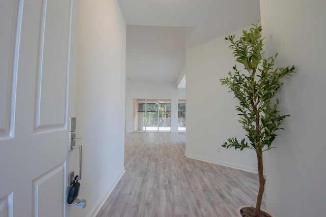 foyer with light wood-type flooring and baseboards