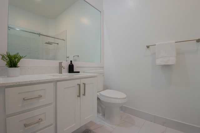 bathroom with toilet, a stall shower, baseboards, and vanity