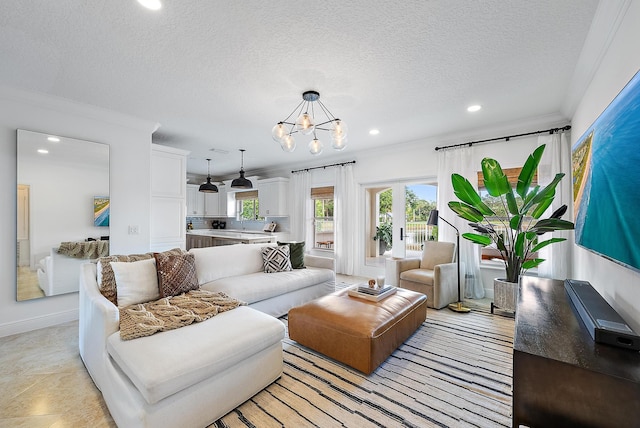 living room featuring crown molding, a textured ceiling, and an inviting chandelier