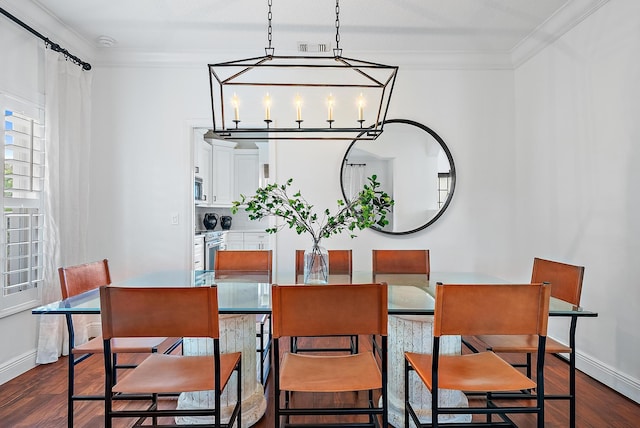 dining area featuring an inviting chandelier, crown molding, and dark wood-type flooring