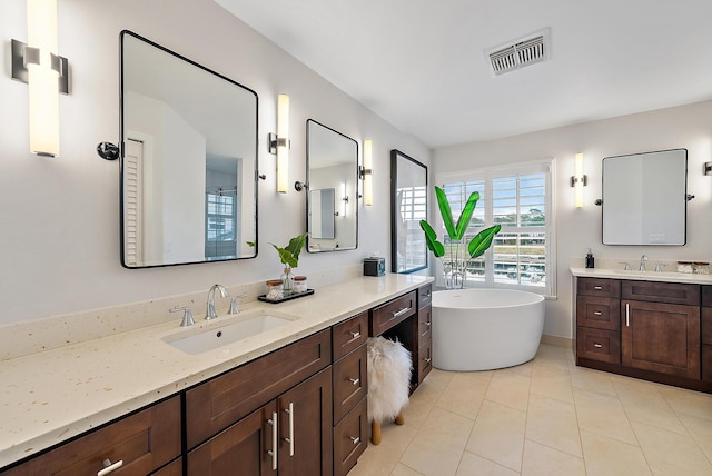 bathroom featuring tile patterned flooring, vanity, and a bathtub