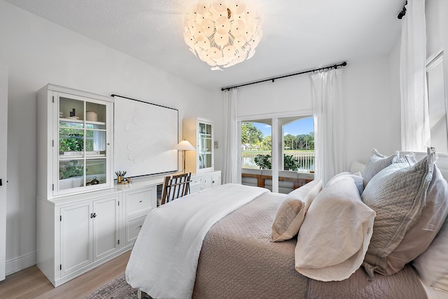 bedroom featuring access to outside and light wood-type flooring