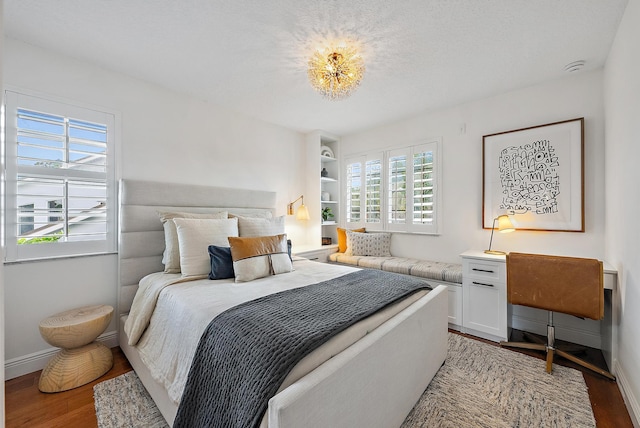 bedroom with hardwood / wood-style floors and a textured ceiling