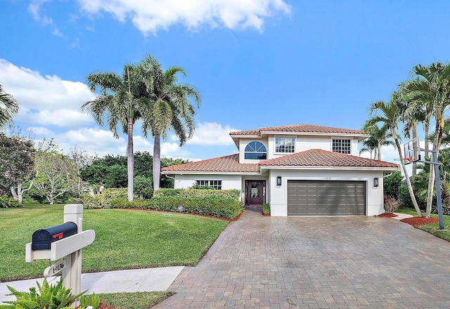 mediterranean / spanish house with a front yard and a garage