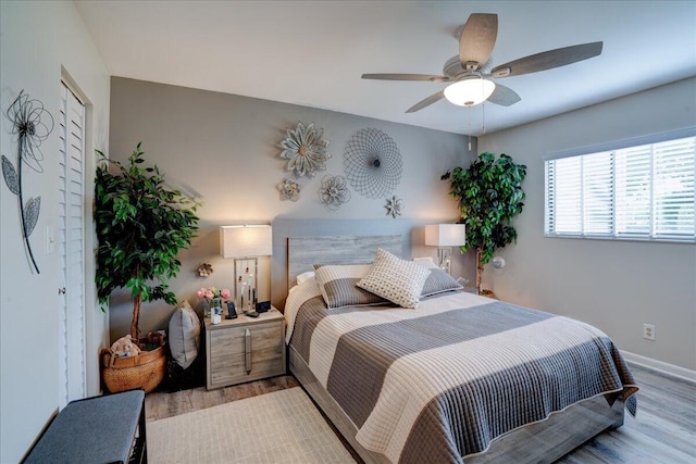 bedroom featuring light hardwood / wood-style flooring and ceiling fan