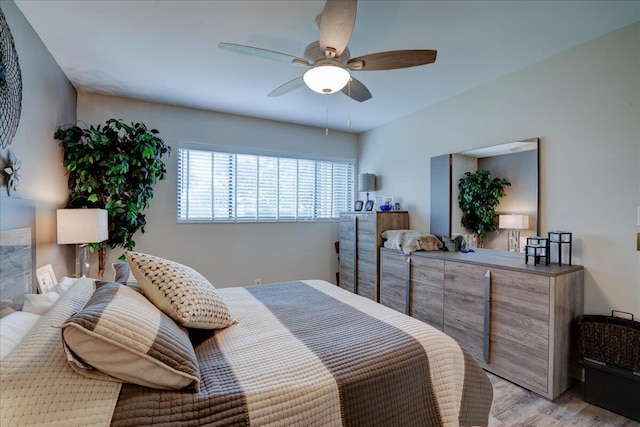 bedroom with light hardwood / wood-style floors and ceiling fan