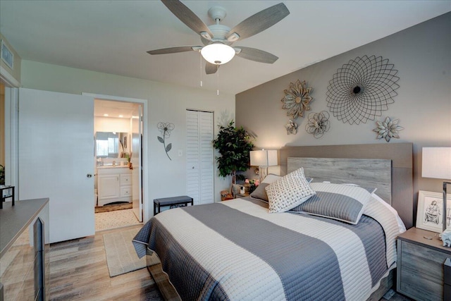 bedroom with a closet, light wood-type flooring, ensuite bathroom, and ceiling fan