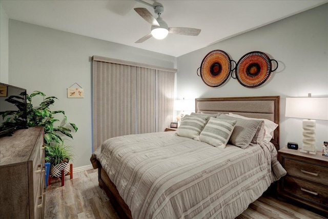 bedroom with hardwood / wood-style flooring and ceiling fan