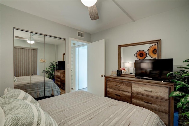 bedroom with ceiling fan and a closet