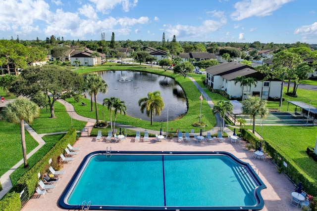 view of swimming pool featuring a patio and a water view