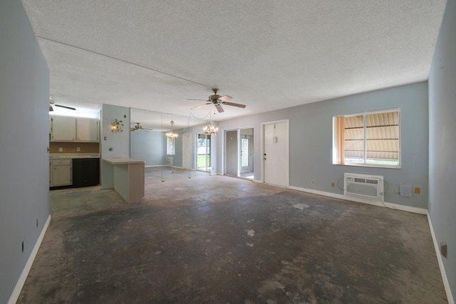 unfurnished living room with ceiling fan with notable chandelier, a textured ceiling, a wall unit AC, and concrete floors