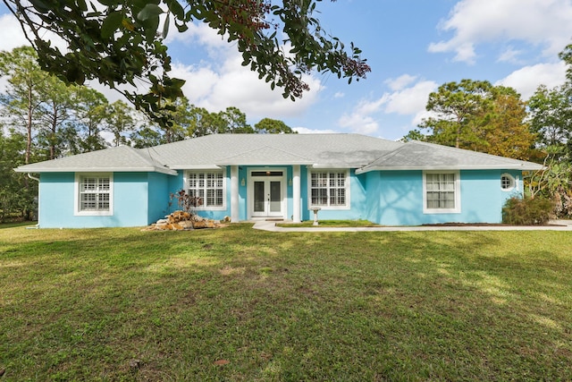 ranch-style home featuring a front lawn and french doors