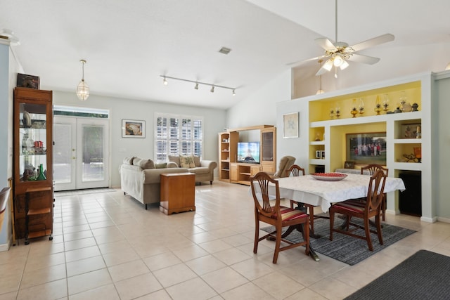 dining room featuring lofted ceiling, ceiling fan, built in features, light tile patterned floors, and french doors