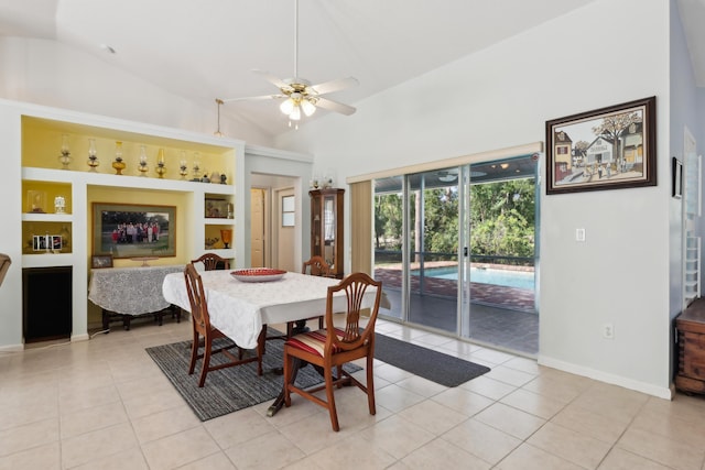 dining space featuring ceiling fan, light tile patterned flooring, lofted ceiling, and built in features