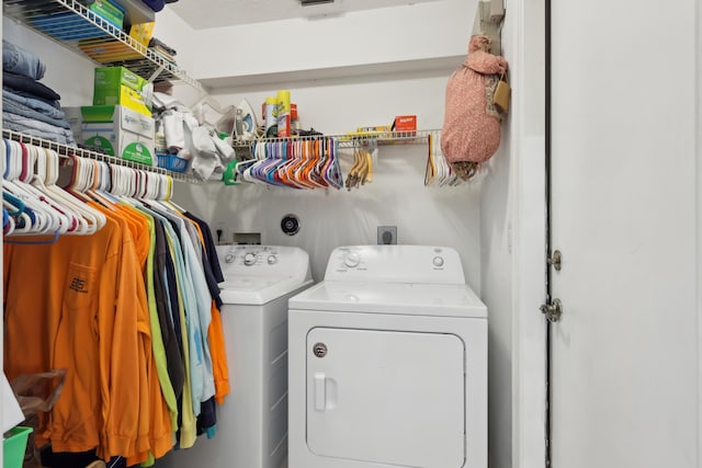 laundry area with washing machine and clothes dryer