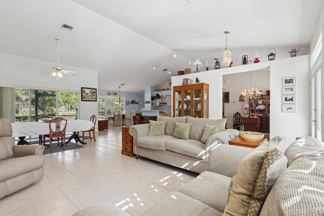 living room with high vaulted ceiling, light tile patterned floors, and ceiling fan with notable chandelier