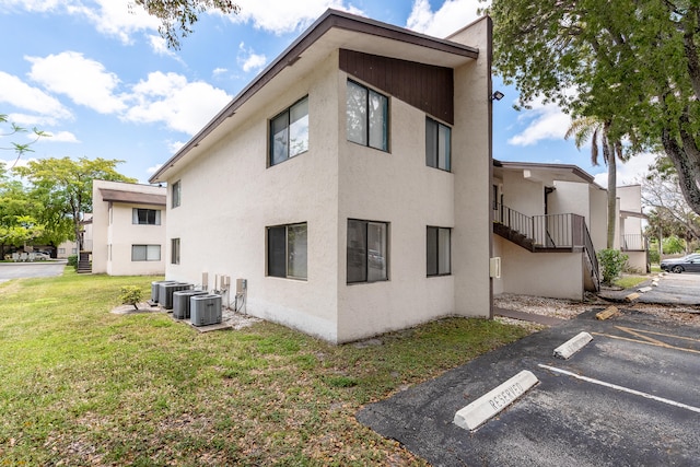 view of property exterior featuring a yard and cooling unit