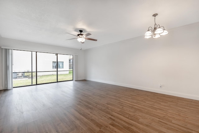 empty room with dark wood-type flooring and ceiling fan with notable chandelier