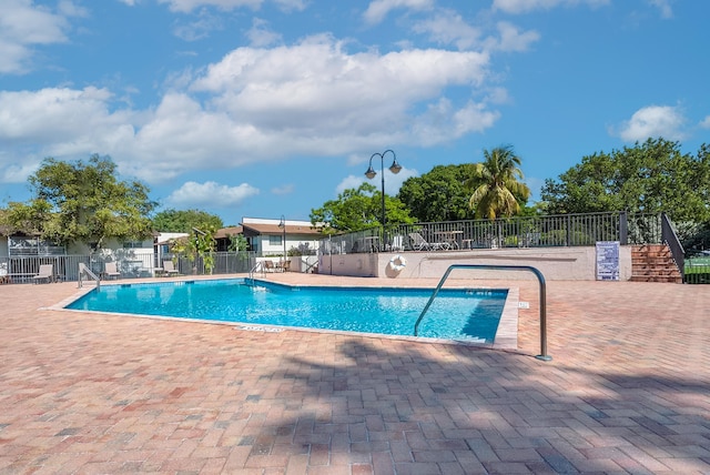 view of swimming pool with a patio